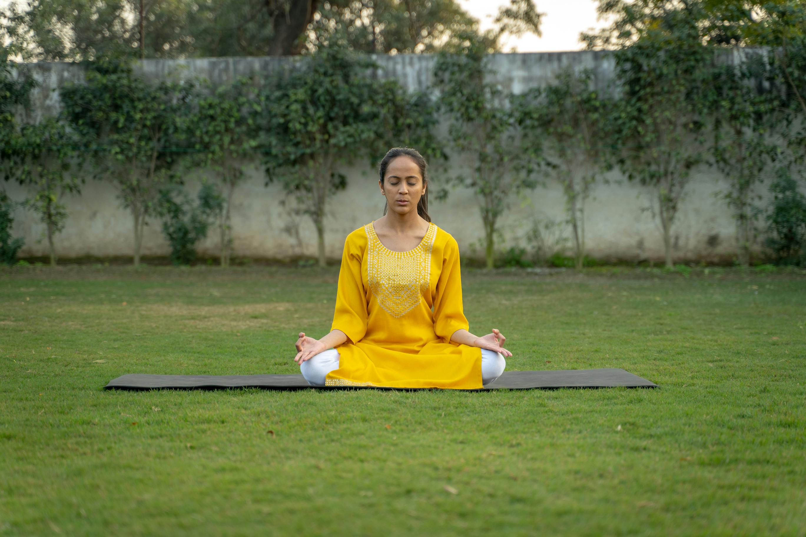 Person meditating in a quiet corner of the club's garden